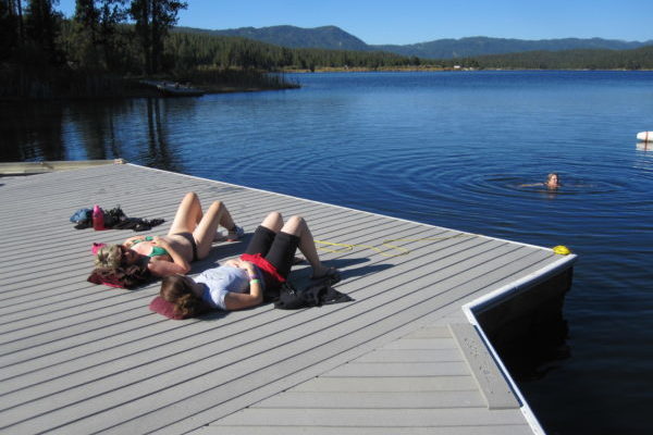 Friends on dock sunbathing